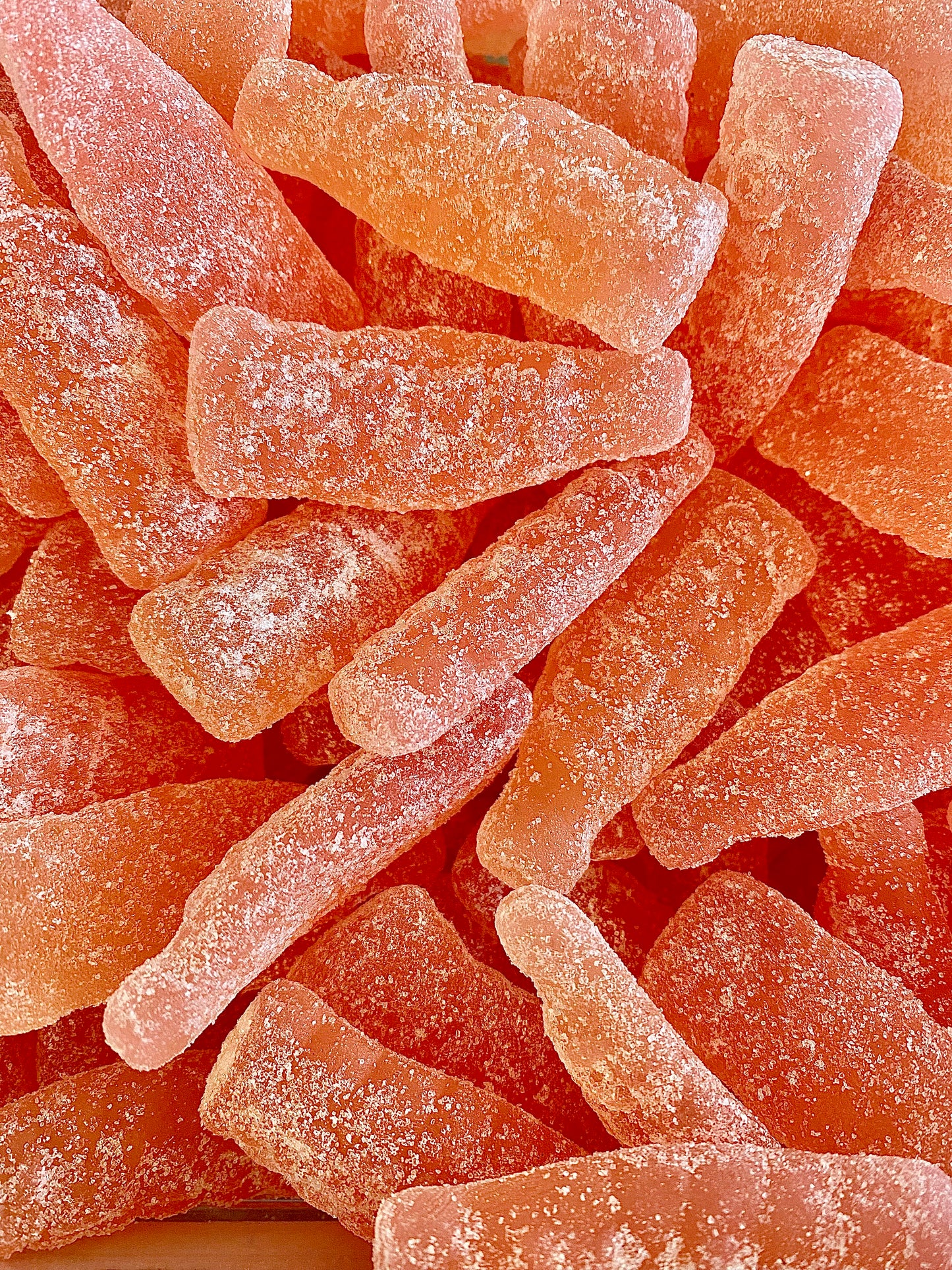 Close-up of pink gummy sour grapefruit with a textured surface. Swedish candy