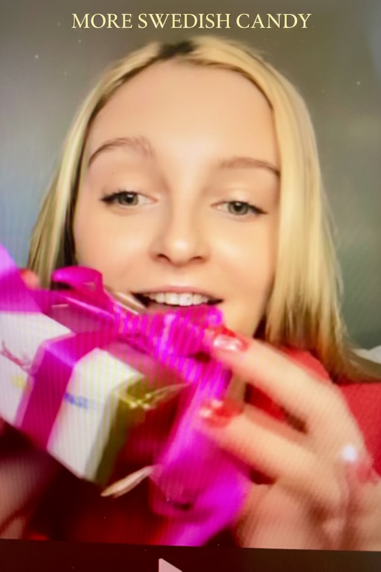 A close-up lifestyle shot of a blonde woman holding a small white gift box with a bright pink ribbon and bow, with the text 'MORE SWEDISH CANDY' visible at the top.