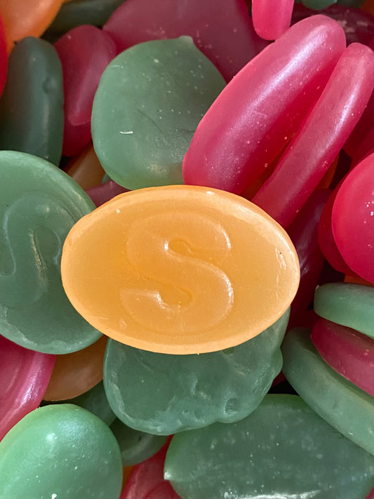 Colorful jelly swedish candy with a yellow 'S' bean on top