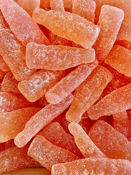 Close-up of pink gummy sour grapefruit  with a textured surface. Swedish candy