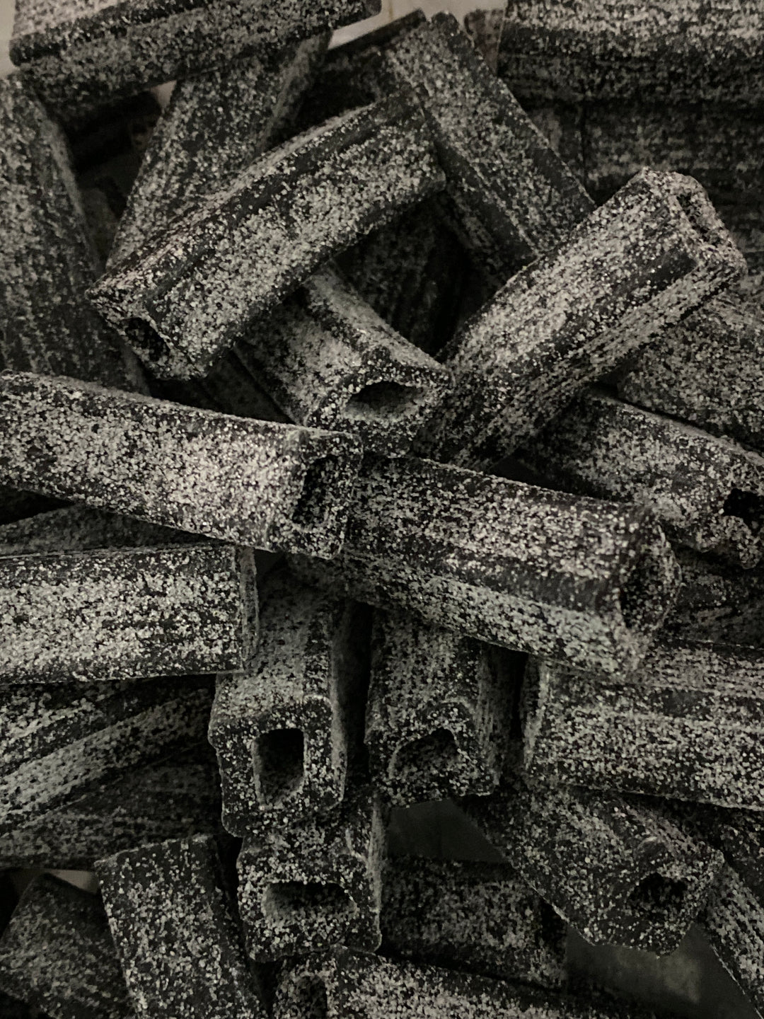 Close-up of salty licorice black and white letters on a background