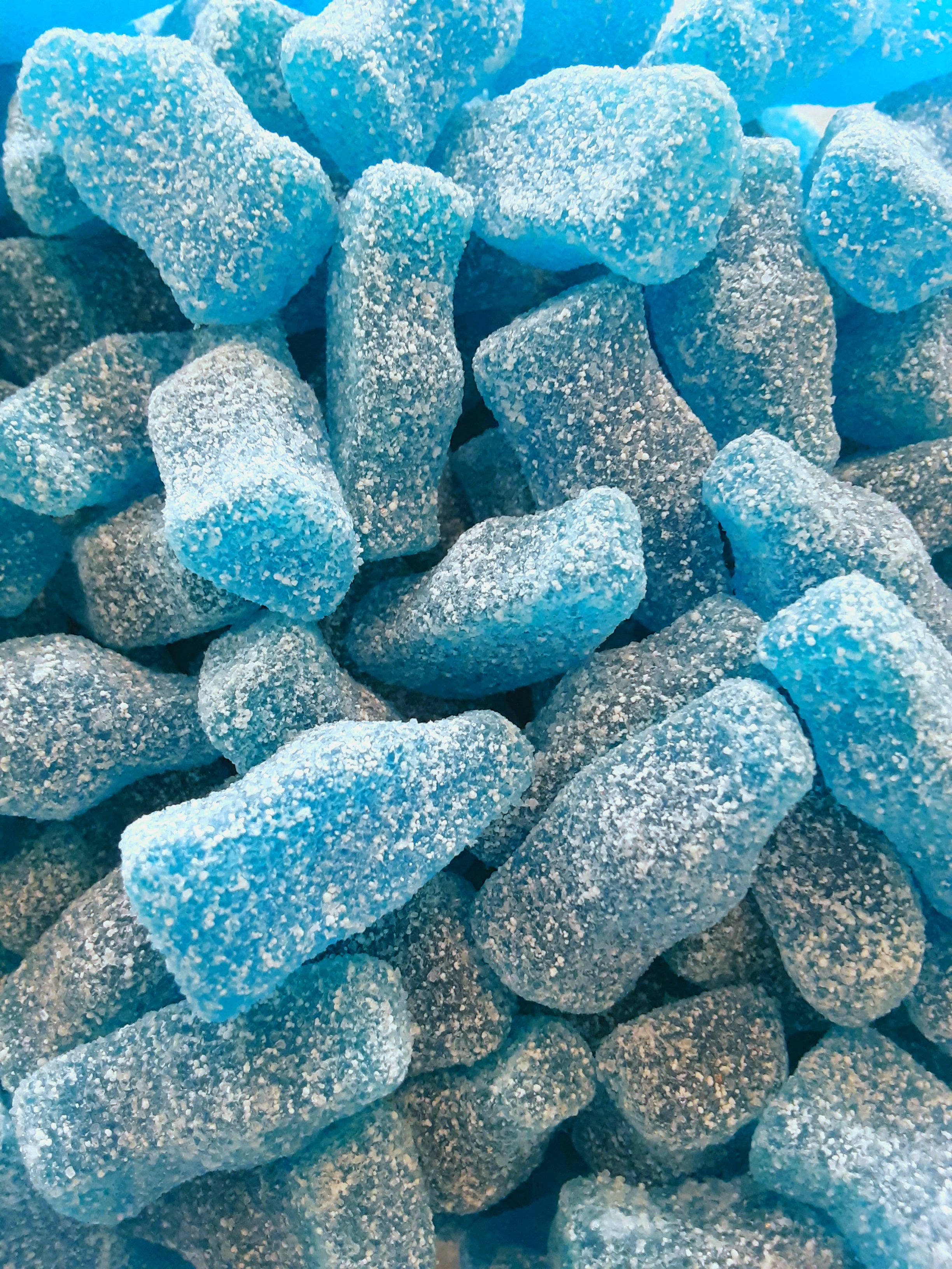 Close-up of blue gummy bears with a blue background