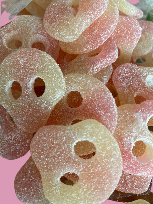 Close-up of pink and white gummy candy with holes