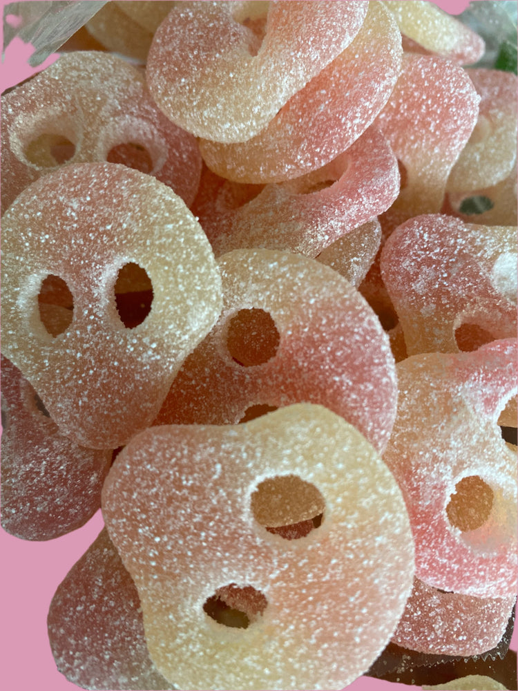 Close-up of pink and white gummy candy with holes