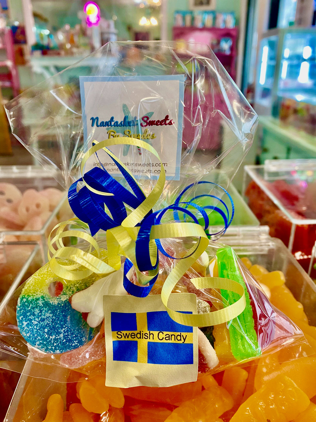 Packaged Swedish candy with ribbons and a visible brand tag in a store setting.
