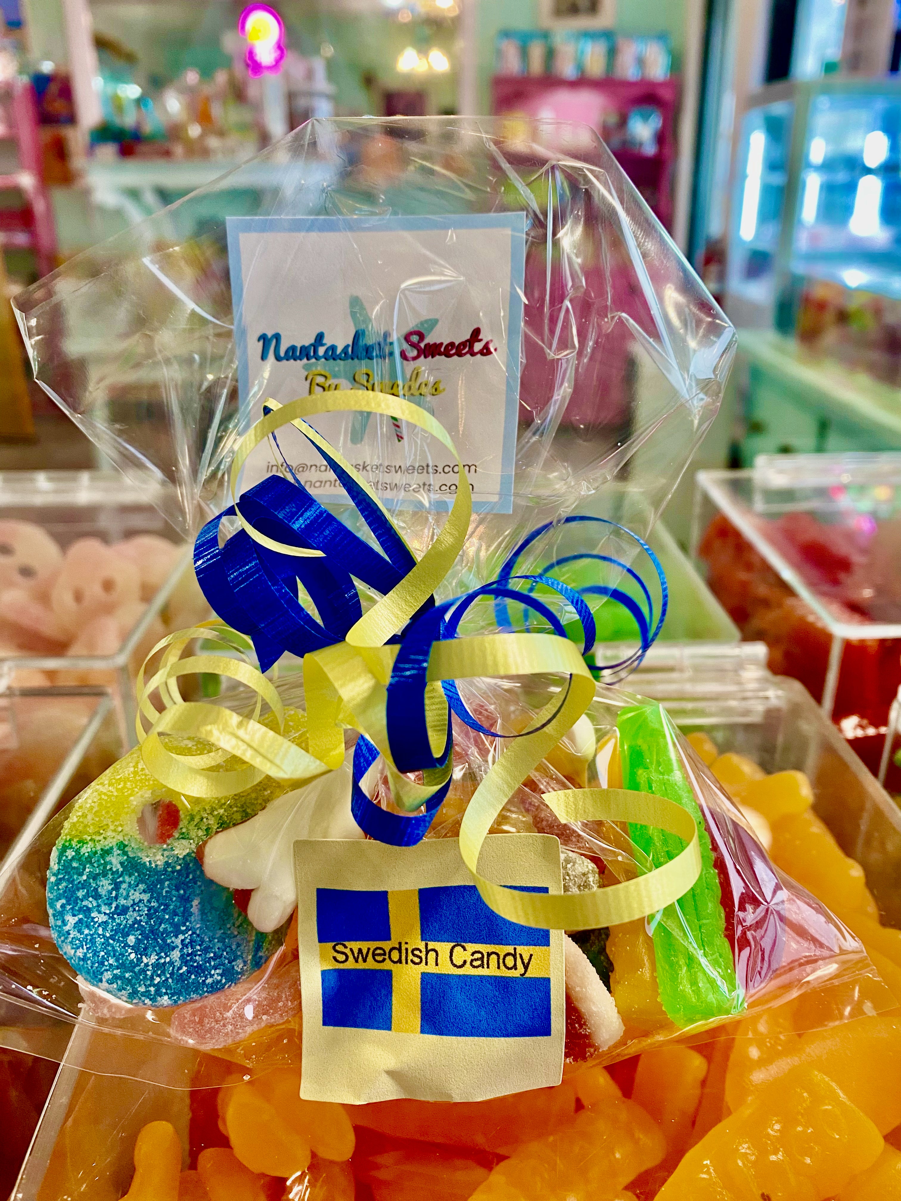 Packaged Swedish candy with ribbons and a visible brand tag in a store setting.